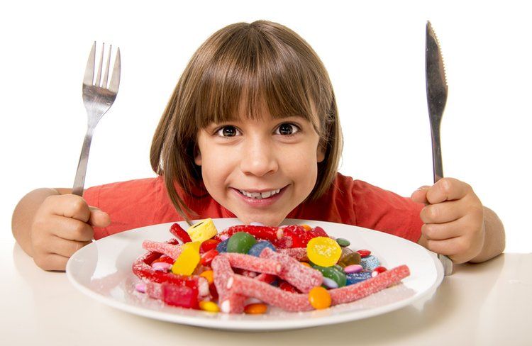 Child Eating A Plate Of Candy