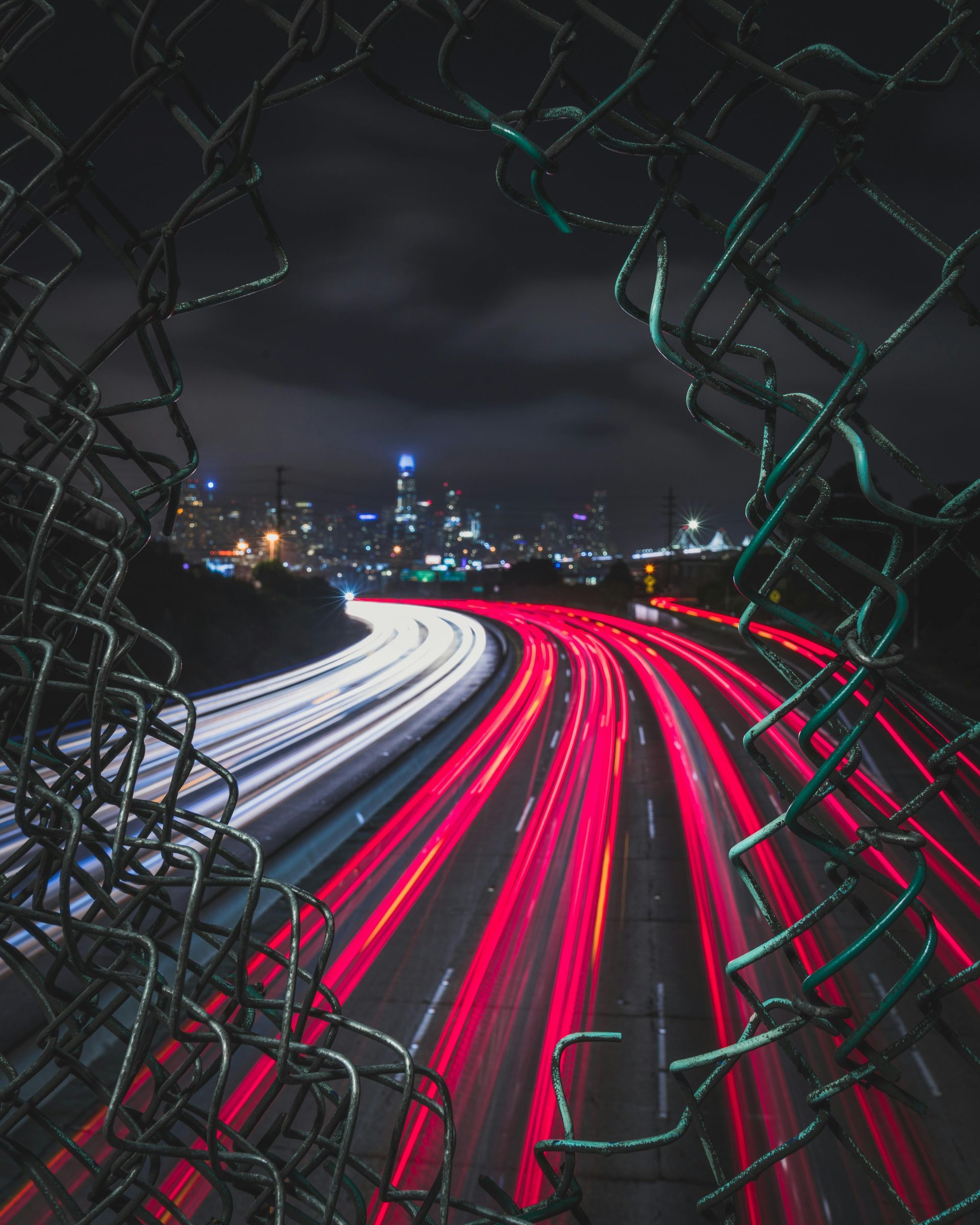 gap in fence with traffic in view