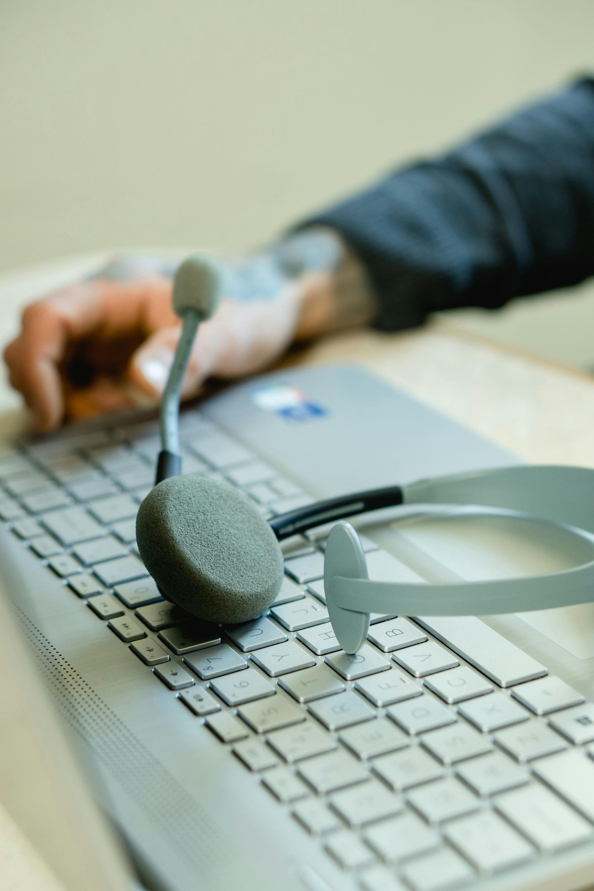 laptop-with-headset-resting-on-keyboard