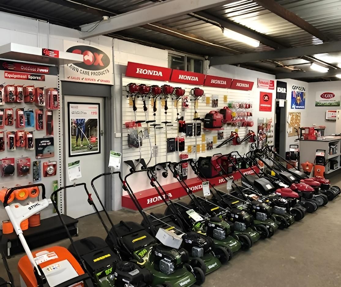 A Row of Lawn Mowers Are Lined Up in a Store — Urunga Chainsaw and Mower in Urunga, NSW