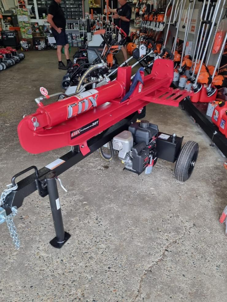 A Red Log Splitter is Sitting on a Trailer in a Store — Urunga Chainsaw and Mower in Urunga, NSW