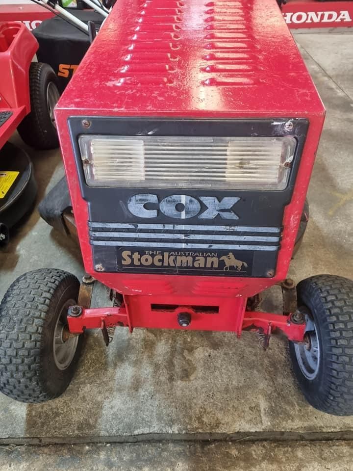 A Red Cox Stockman Lawn Mower is Parked in a Garage — Urunga Chainsaw and Mower in Urunga, NSW