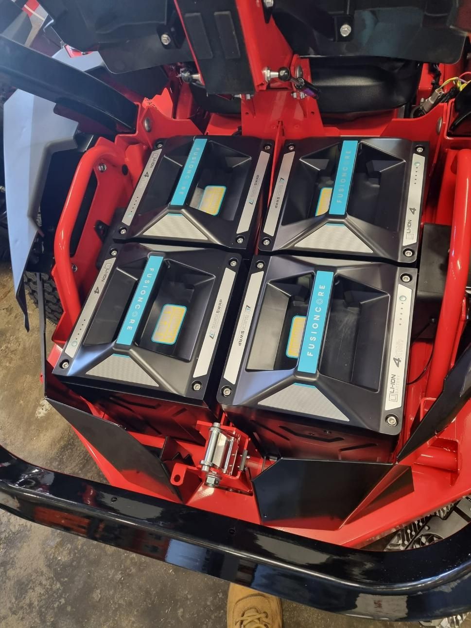 A Red Atv With a Bunch of Batteries on It — Urunga Chainsaw and Mower in Urunga, NSW