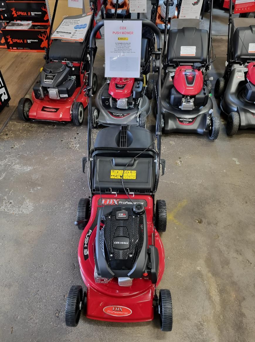 A Row of Lawn Mowers Are Lined Up in a Store — Urunga Chainsaw and Mower in Urunga, NSW