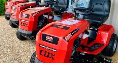 A Row of Red Lawn Mowers Are Parked Next to Each Other — Urunga Chainsaw and Mower in Urunga, NSW
