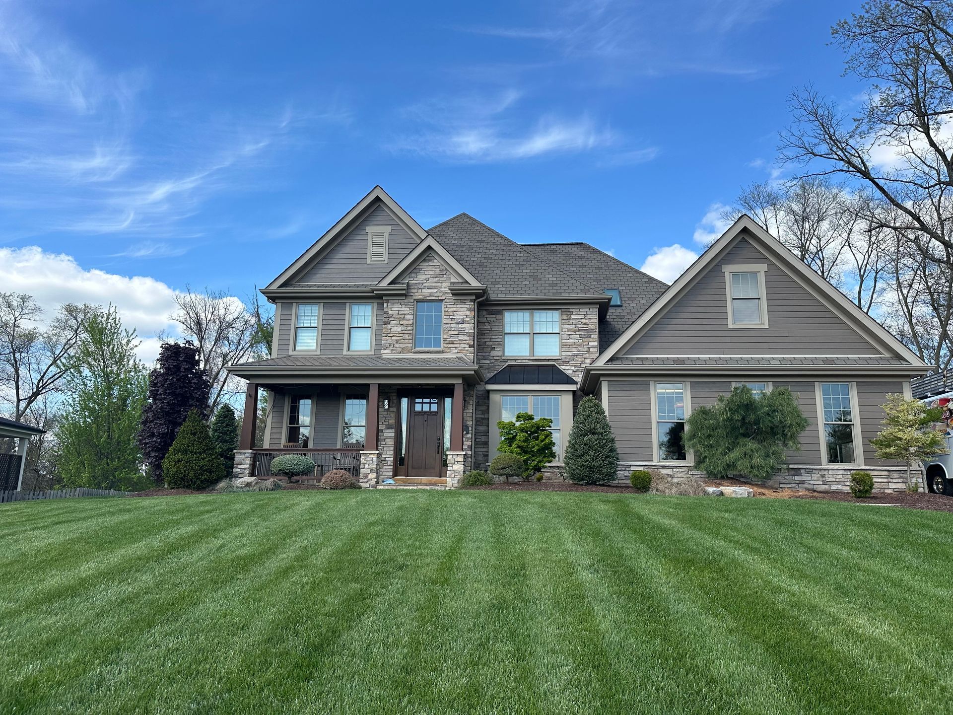 A large house with a lush green lawn in front of it.