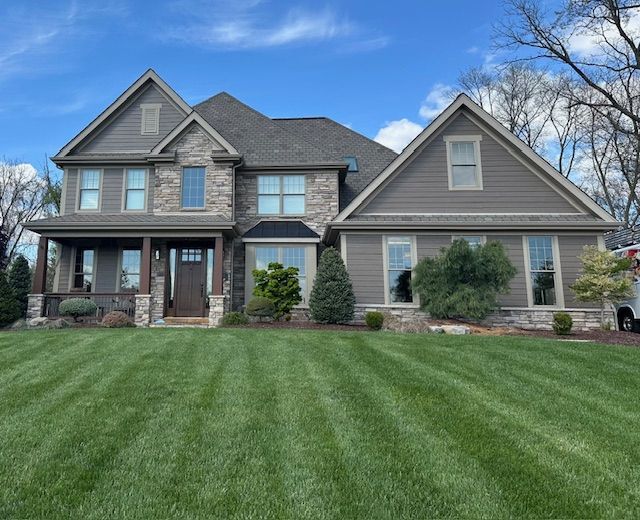 A large house with a lush green lawn in front of it