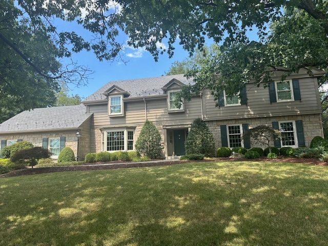 A large house with a large lawn in front of it