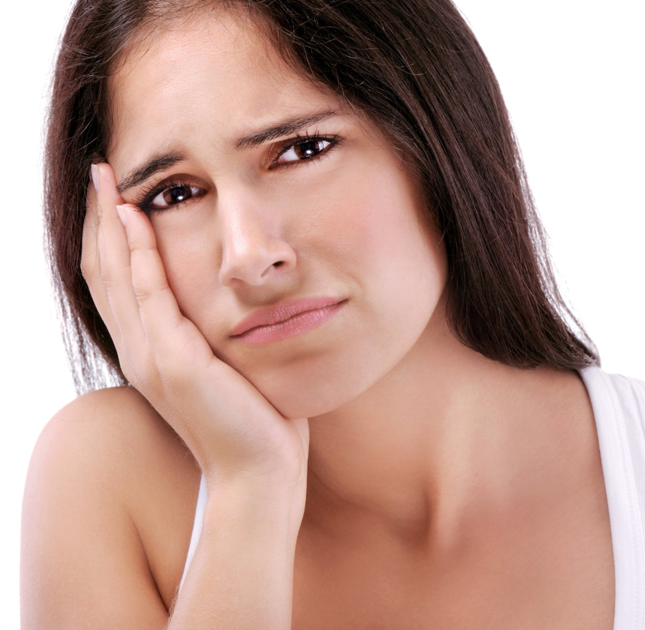 Woman holding her cheek with a pained expression on a white background
