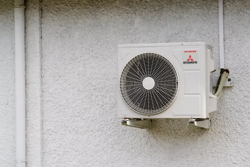 A person is cleaning an air conditioner with a filter.