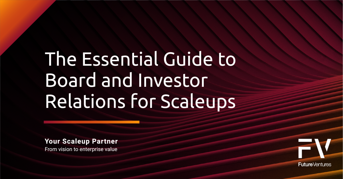 Two men in suits shaking hands in a business setting.