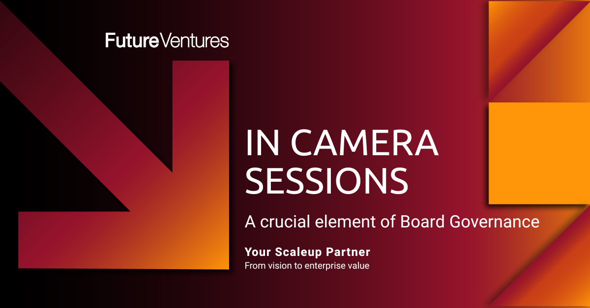 An image of a businessman and a businesswoman sitting at a table in corporate setting