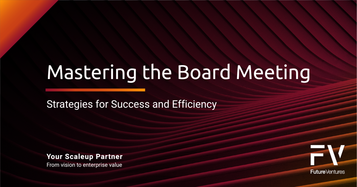 A group of people are sitting at a table with laptops.