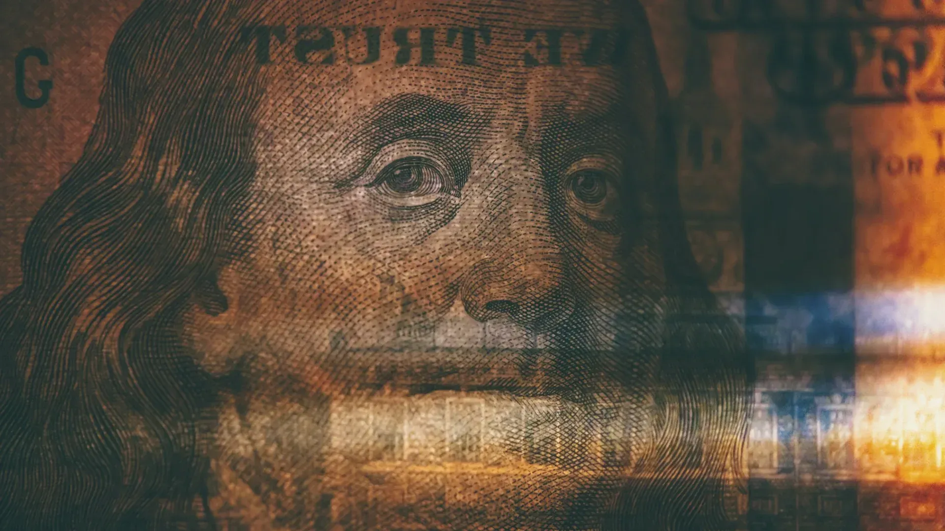 Close-up of a $100 bill, with Benjamin Franklin's face, overlaid with blurred color stripes.