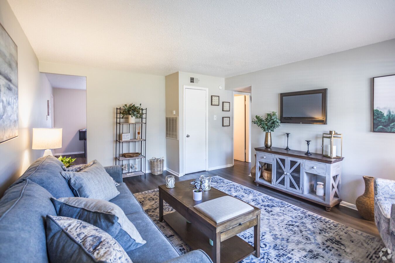 Photo of a living room interior with other rooms in the background