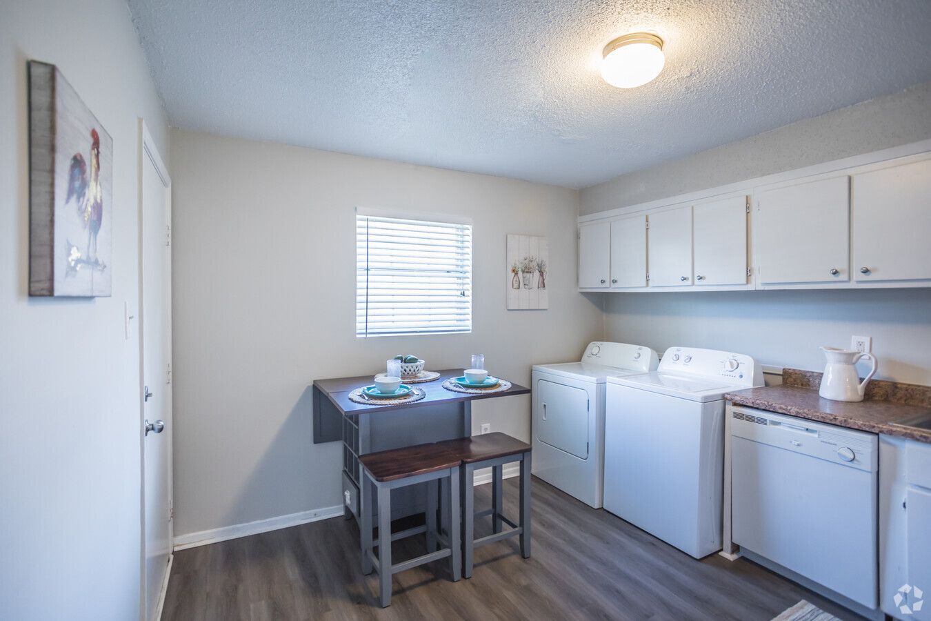 Photo of the kitchen dining area with washer and dryer space