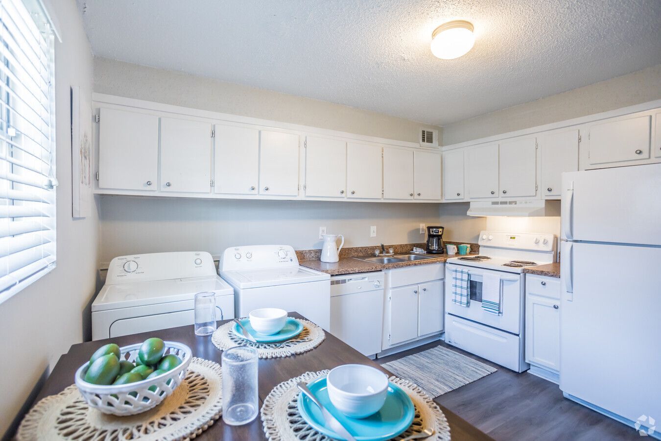 Photo of the kitchen with plenty of cabinetry and space for washer and dryers as well