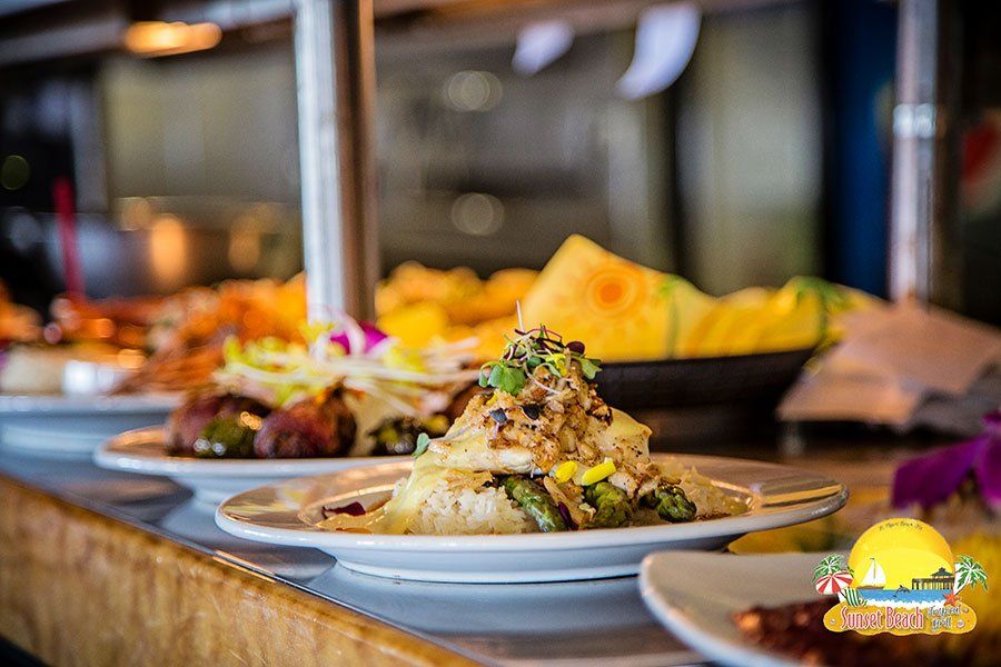 Plates of food on a counter at a restaurant with visible ingredients and details.
