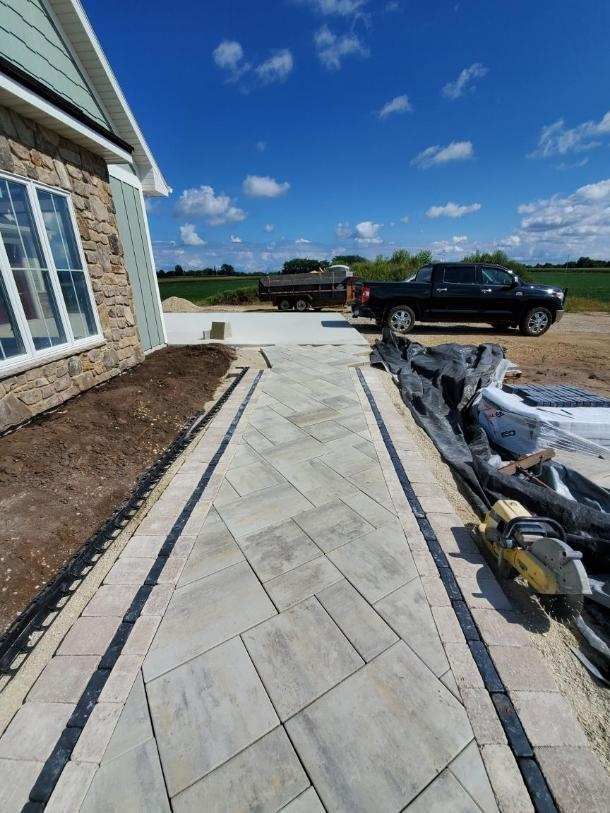 A concrete walkway is being built in front of a house.