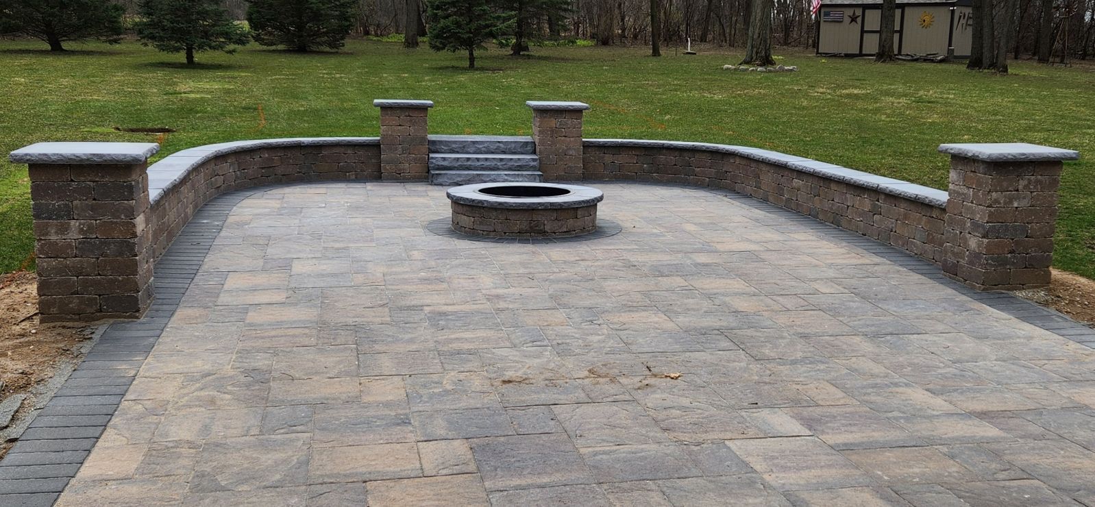 There is a fire pit in the middle of the patio.