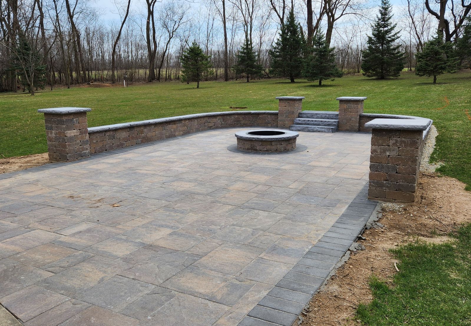 There is a fire pit in the middle of the patio.