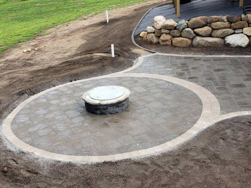 There is a fire pit in the middle of the patio.