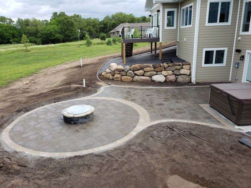 Firepit surrounded by a newly installed brick patio with edging