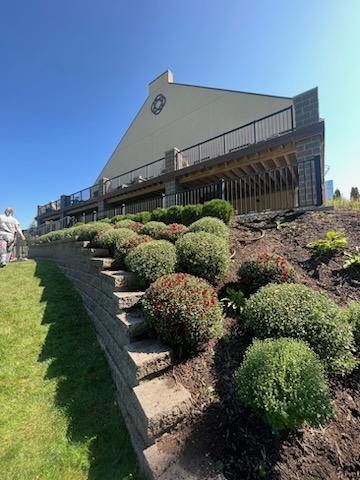 A large building with stairs leading up to it is sitting on top of a hill.