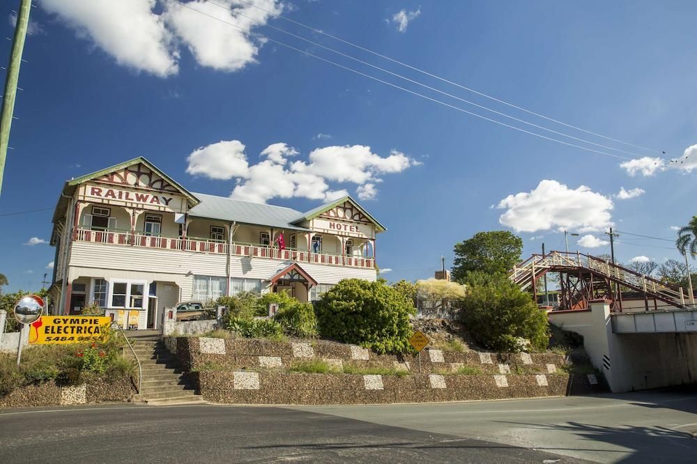 A Large White Building With Stairs Leading Up to It is Sitting on Top of a Hill — Median Law In Gympie, QLD