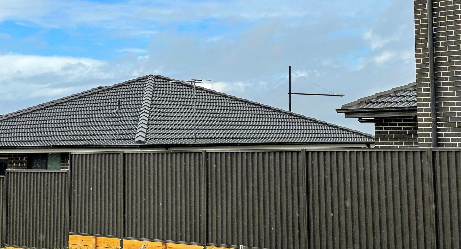 An artist 's impression of a house with a blue roof