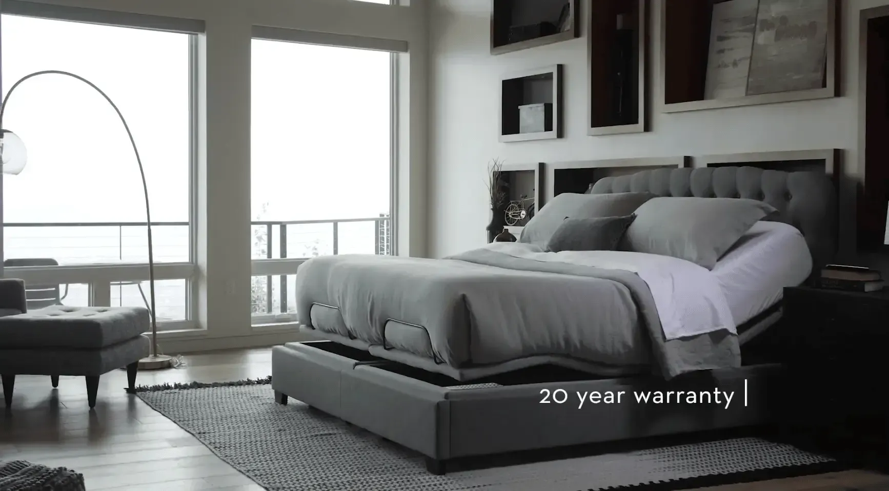 The Malouf S755 in a bedroom with grey pillows and duvet with caption 20 year warranty