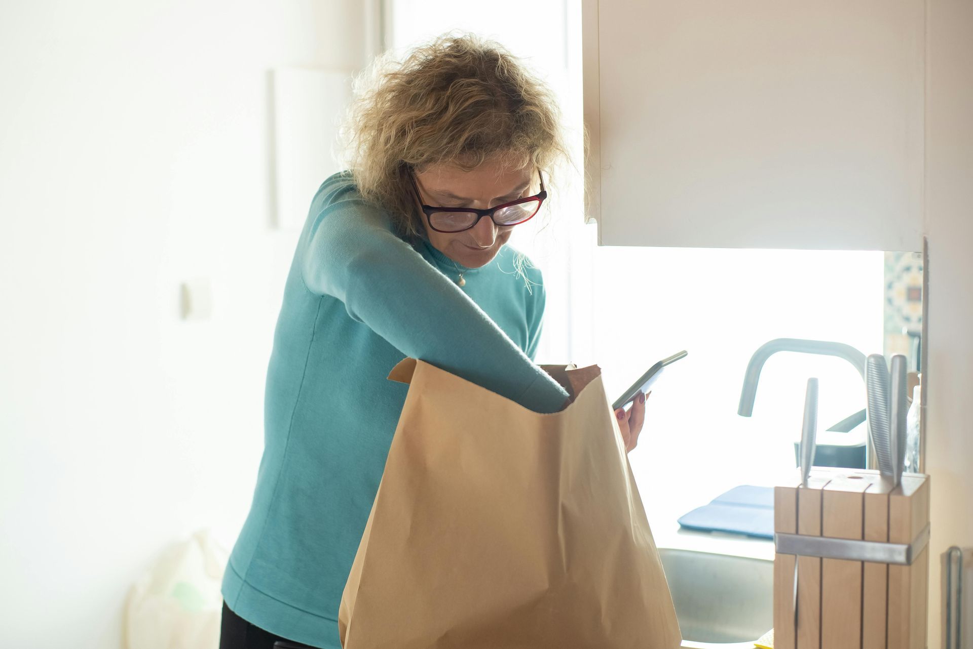 A family is walking through a field holding hands.