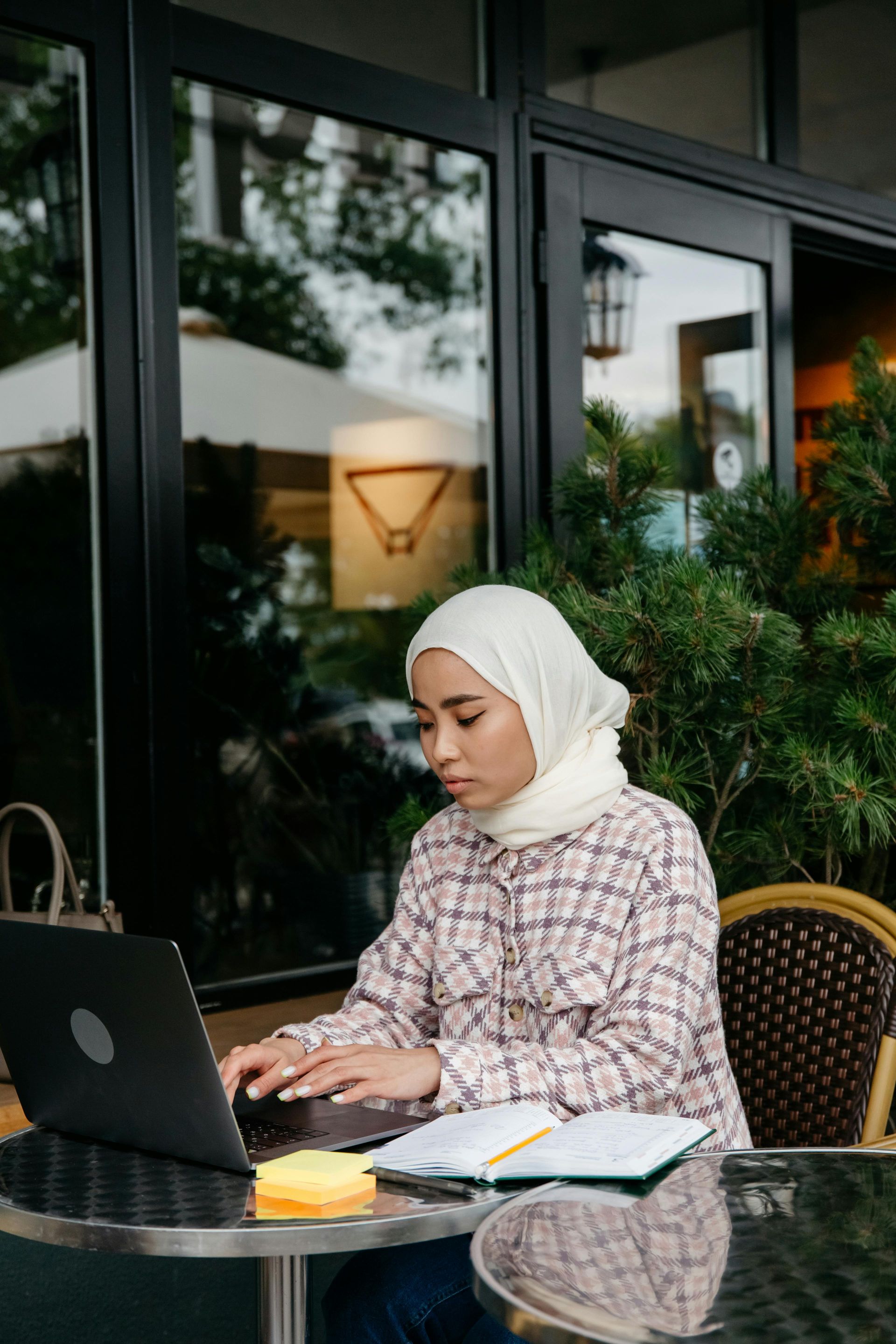 A family is walking through a field holding hands.