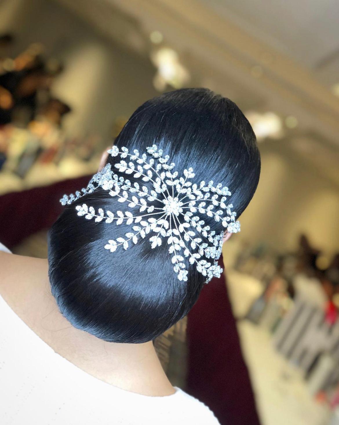 bride with slicked back bun and hair accessory