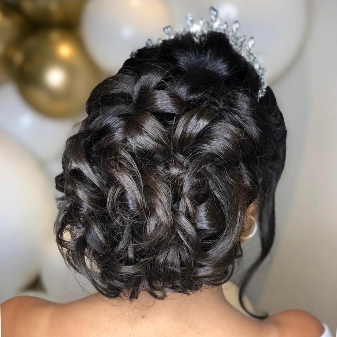 bride with curls in a bun and hair accessory