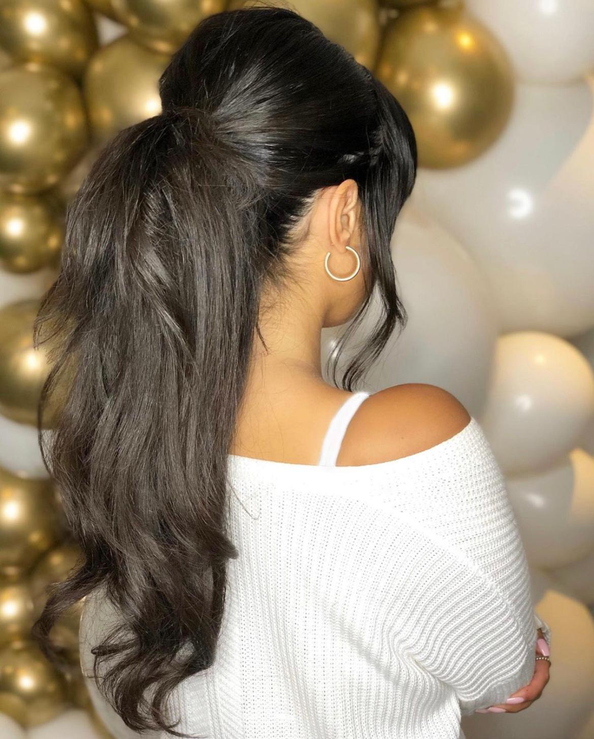 brunette woman with long hair and ponytail