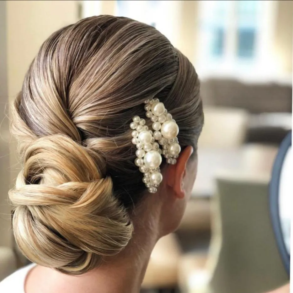 woman with blonde hair in low bun and hair accessory