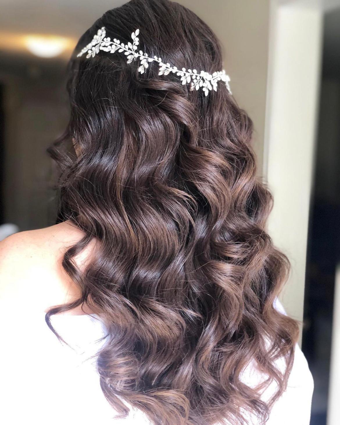 bride with long hair with curls and hair accessory