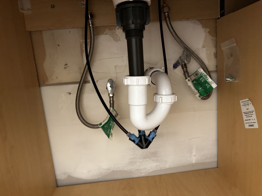 A bathroom sink with a hose attached to it