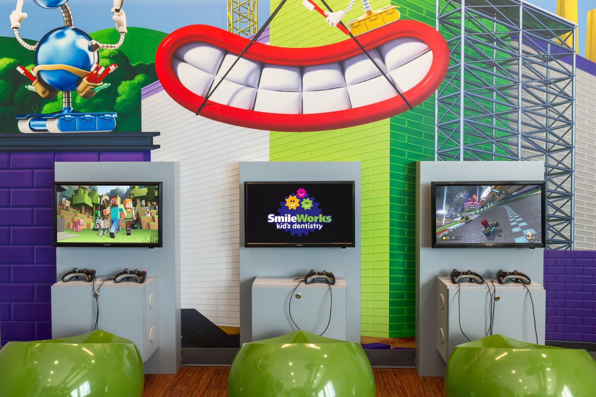A video game room with a large mouth on the wall