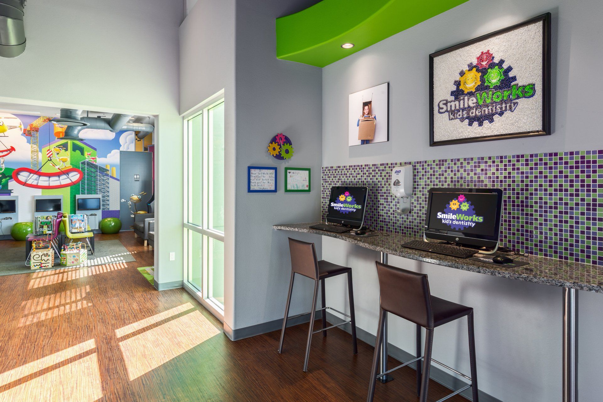 An artist 's impression of a children 's room with computers and chairs.