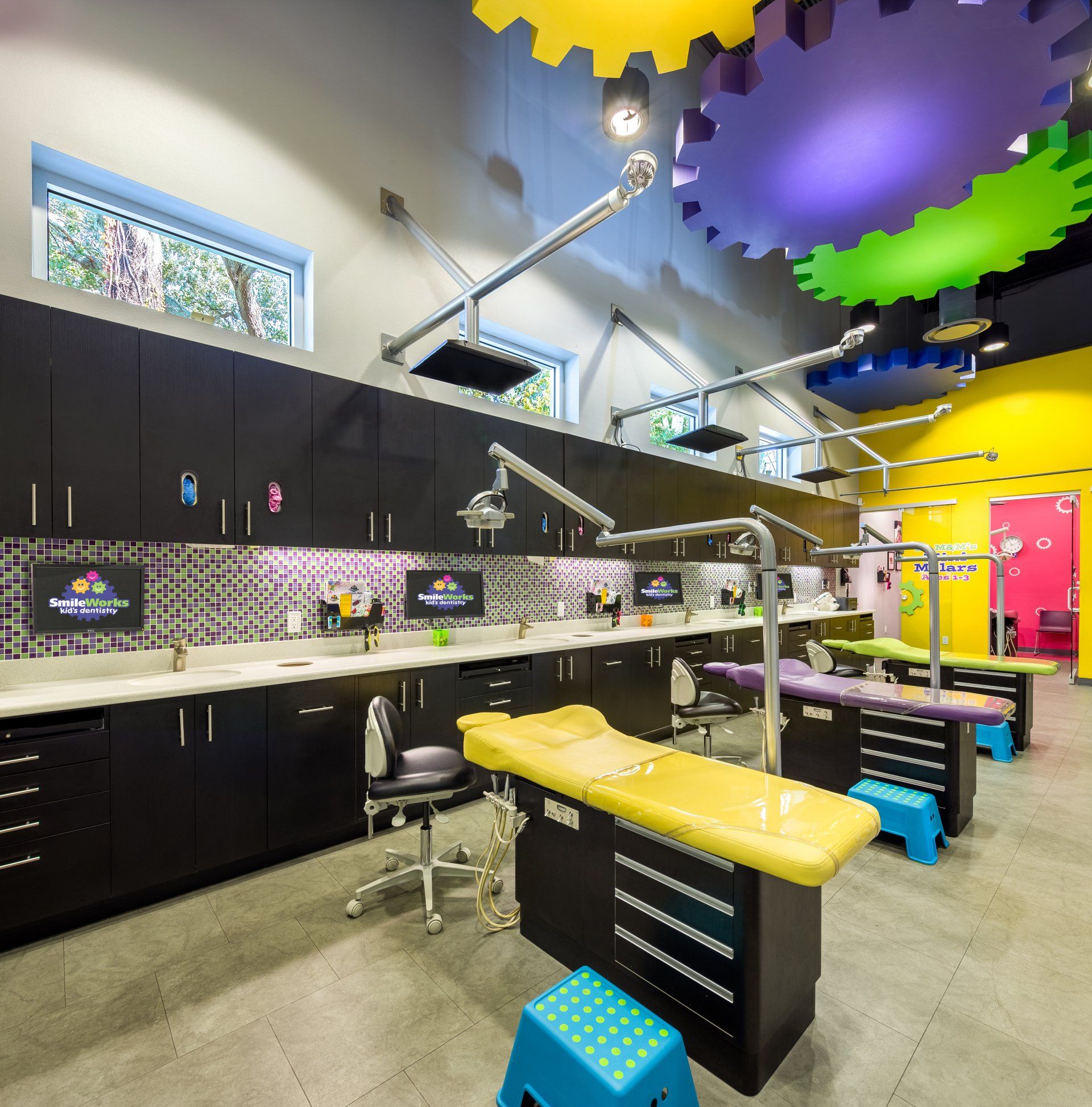 A dental office with a purple and yellow ceiling