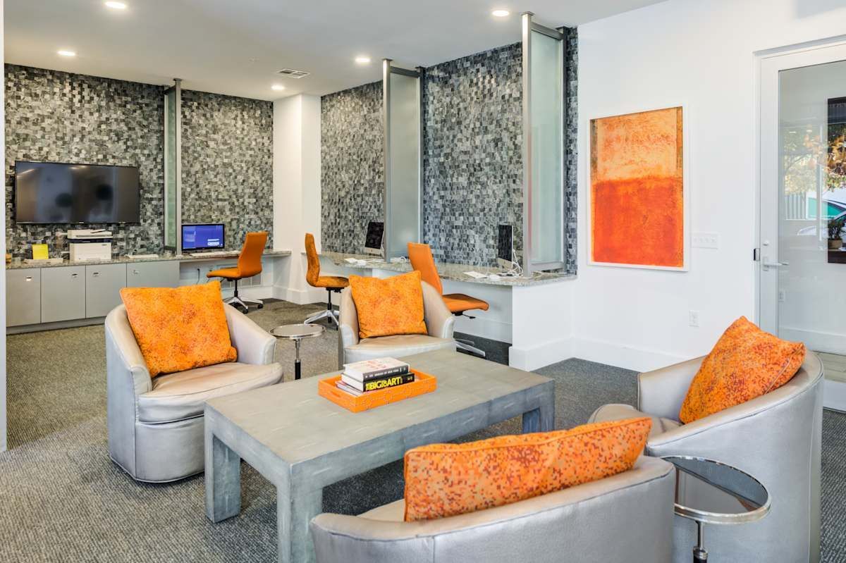 A living room with chairs , a table , and a television.