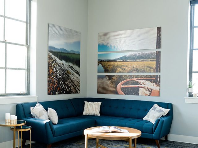 people looking at mounted prints on the wall