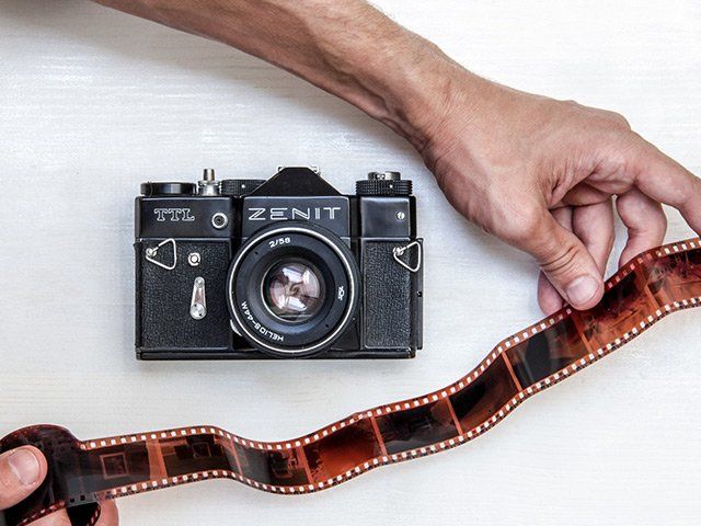 a person is holding a roll of film in their hand .