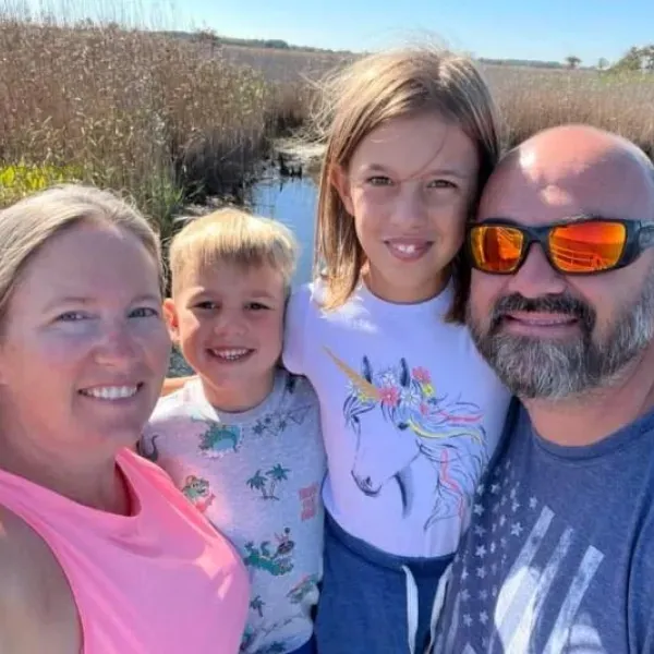 Stone veneer wall with gray, orange, and tan rectangular pieces arranged in a staggered pattern.