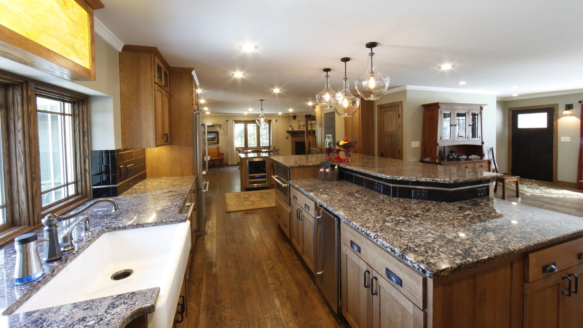 Spacious kitchen with wood cabinets, granite countertops, and a large island.