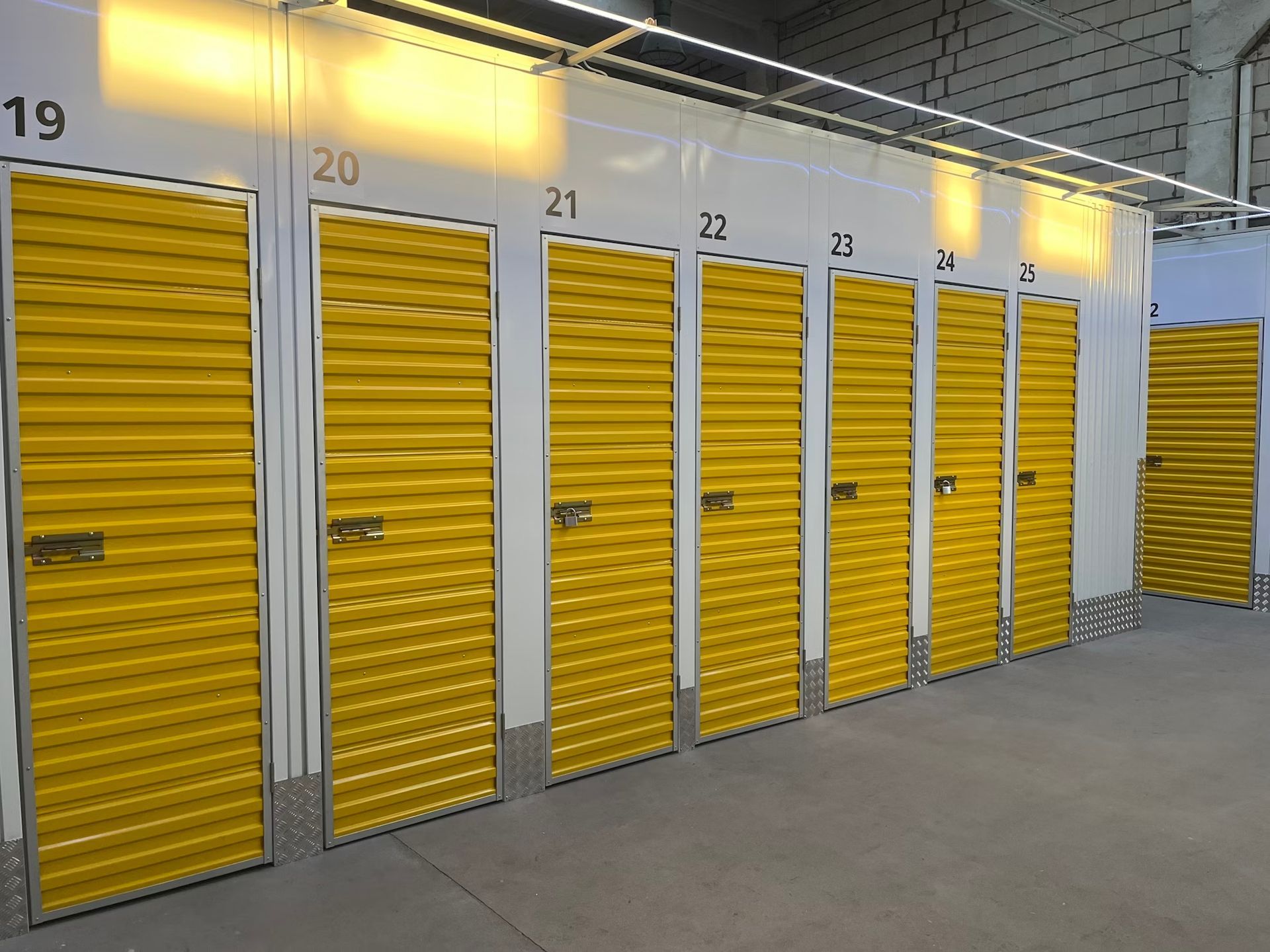 Row of self-storage units with yellow doors.