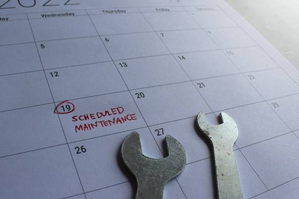 A wrench is sitting on top of a calendar.