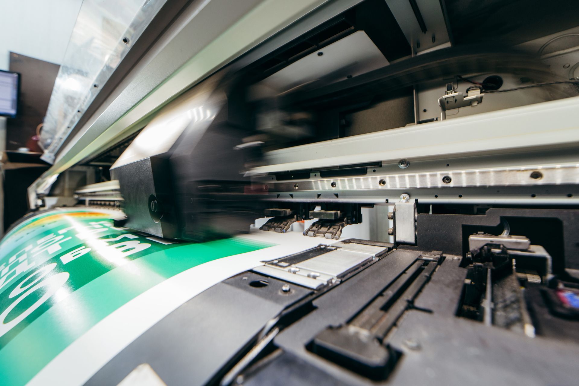 A large printer is printing a large piece of paper. - Port Saint John, FL - Shipping Depot of Port St John